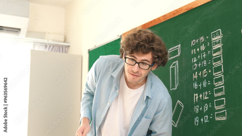 Poster caucasian teacher looking at student while standing at blackboard. low angle camera of professional 