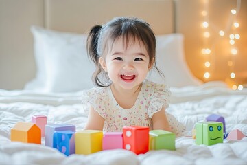 Naklejka premium Cute little happy child girl sitting play colorful toys at bed in home room.Asian baby lifestyle and education. generative ai