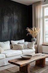 Elegant living space with a refined black wall, a cozy white sofa, and a wooden coffee table near a window. 