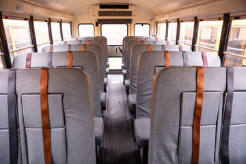 Interior of empty school bus with seat belts © ejgrubbs