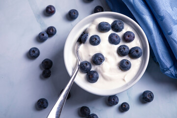 Tasty liquid texture of yogurt with blueberry. Creamy dairy product.