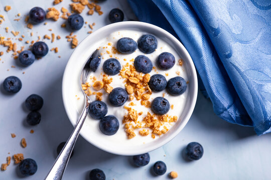 Healthy light diet breakfast of blueberries and yogurt and crunchy granola