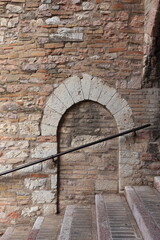 Assisi Street View with Stairs and Arch in a Stone Wall in Umbria, Italy