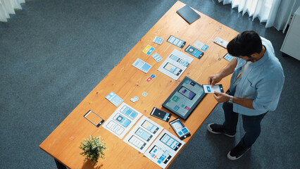 Top down view of male leader using phone to call manager while walking at meeting table. Professional businessman talking or discussing with smart manager about business plan or strategy. Convocation.