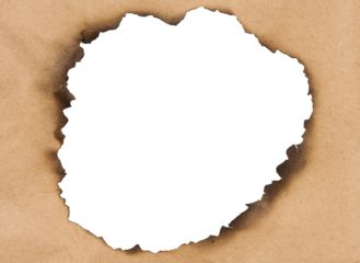 Fire burnt hole in brown paper on isolated background