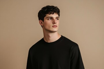 Stylish male model showcasing modern fashion against a neutral backdrop