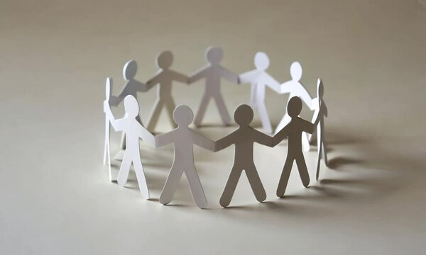 A group of people are holding hands in a circle