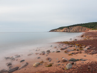 Pebbles dotting Broad Cove Beach in Cape Breton Highlands National Park, Nova Scotia, Canada.