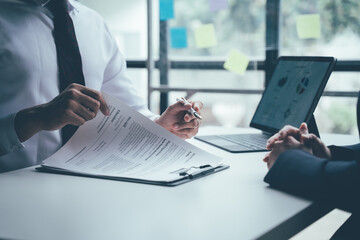 Job Interview Focus: A focused professional in a business suit, reviewing a resume in a job...