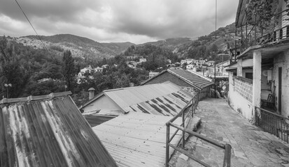 Fototapeta premium Street and house view of Phini (Foini), a picturesque, natural beauty mountainous village, of natural beauty, in the Troodos Mountains, located near by the town of Platres, Limassol district, Cyprus