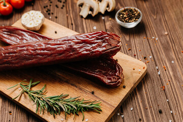 Traditional salami sticks with garlic and herbs, perfect for gourmet meals and charcuterie boards