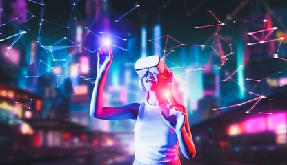 Female stand in cyberpunk style building in meta wear VR headset connect metaverse, future cyberspace community technology. Woman use fingers touch objects, light appear where she stab. Hallucination.