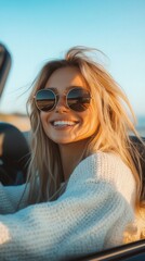 Fototapeta premium Happy woman with sunglasses enjoys a sunny drive along the coast