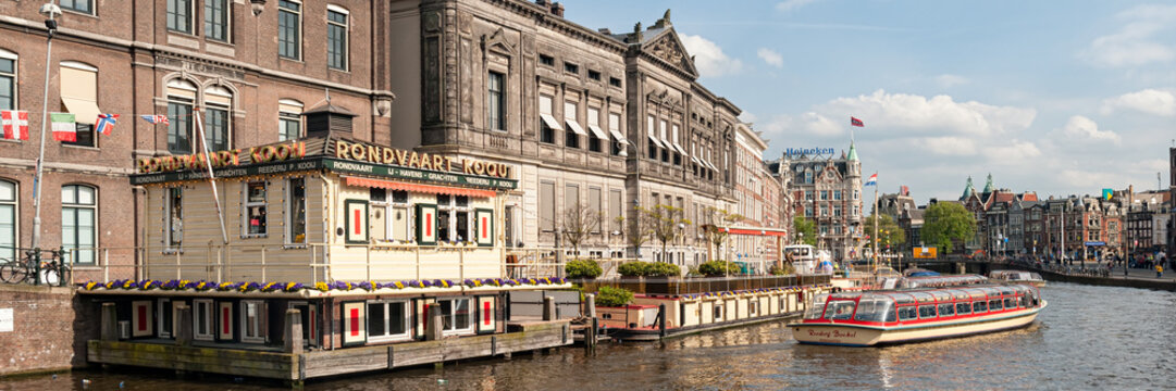 AMSTERDAM, NETHERLANDS - MAY 07, 2012:  Panorama view of Rederij Kooij Tour Boat near the Boarding Point at Rokin