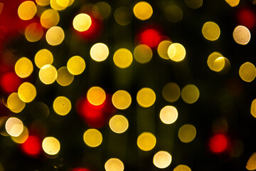 Close up Blurred bokeh effect of Christmas lights in red and gold, creating a festive and warm atmosphere. Holiday backgrounds, creative designs. Copy space