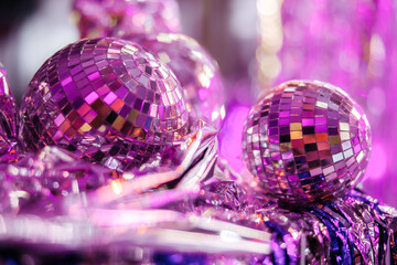 Group of shining disco balls on the floor in neon light. Party concept.
