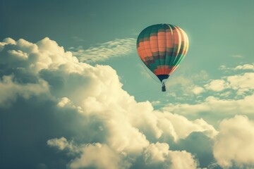 Fototapeta premium Colorful hot air balloon flying above the clouds in a blue sky, freedom, adventure, travel concept