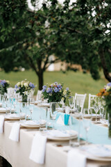 Photo of festive table in summer outdoor. Cozy vibe.