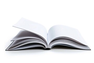 Fototapeta premium A close-up of an open book lying on a white surface, perfect for use in educational or publishing contexts