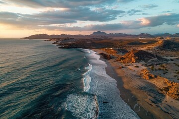 Fototapeta premium Aerial view of a beach at sunset with calm waters and serene atmosphere
