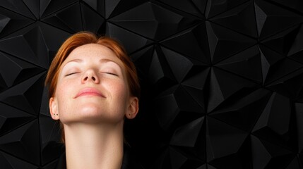 Serene woman with closed eyes against abstract black background