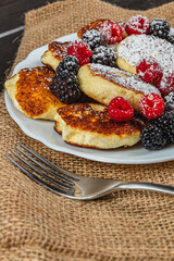 Cottage cheese pancakes with fresh raspberries, blackberries and powdered sugar