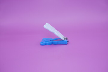 cute nail clippers isolated on purple background. cute nail clippers with blue and white color combination