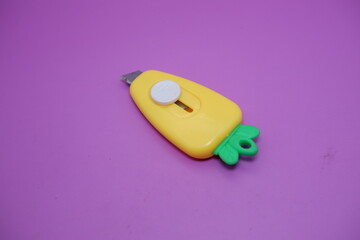 cute mini cutter with carrot shape. cute cutter isolated on purple background.