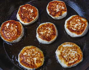 Cottage cheese pancakes are fried in a pan before being pulled out