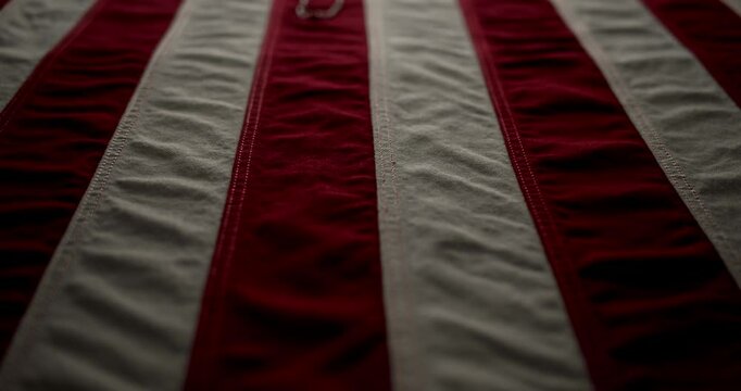 Shiny military dog tags on the red white and blue US American flag. Background for the United States Memorial Day, Armed Forces Day, Veteran's Day, or other patriotic USA holiday.