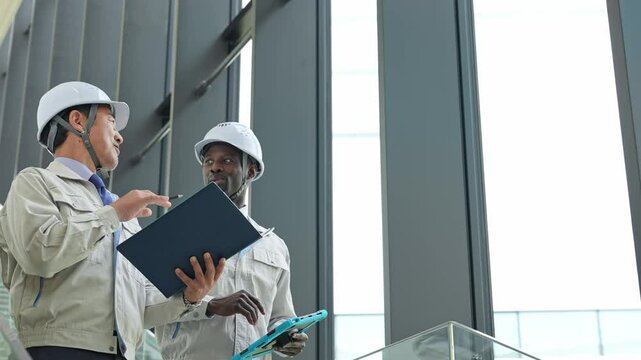 Group of multinational engineers inspecting a building