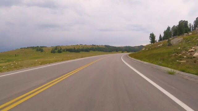 Driving on Beartooth Highway, US Route 212, during summer in Wyoming, USA
