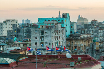 Cuba, Havana. Cuban flags in wind above city skyline. 2016-03-27