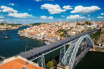 View of Porto city and Douro river with moored sailing ship and Dom Luis bridge I from famous...