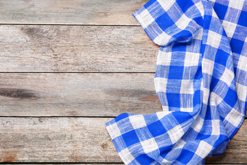 Blue checkered gingham fabric on wooden table