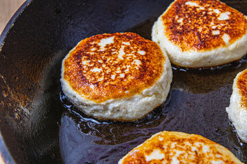 Cottage cheese pancakes are fried in a pan before being pulled out