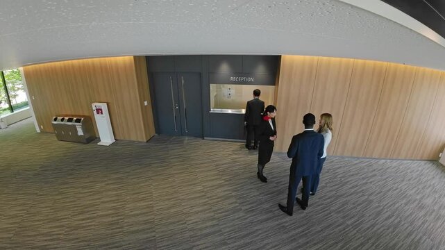 Aerial view of people standing at the hotel reception desk