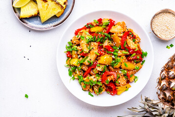 Stir fryed chicken with pineapple, red paprika, chives, soy sauce and sesame seeds. White...