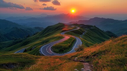 Stunning view of sunset and curved roads from mountain top 