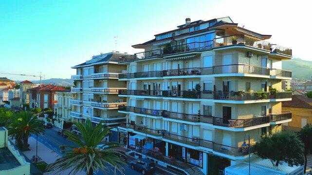 Aerial pedestal up shot of the city centre. Centuries-old palm trees line up along Lungomare Gramsci in this renowned tourist resort and its fine beach