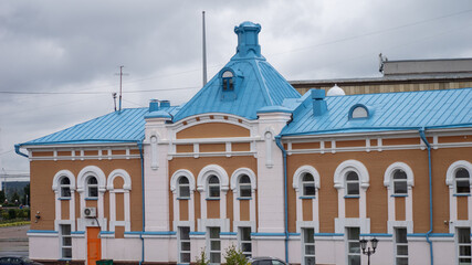 A large building with a blue roof and white trim