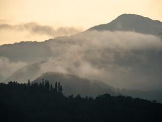 a mountain range with a sunset in the background.
