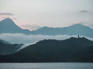 a mountain with a tower on the top of it