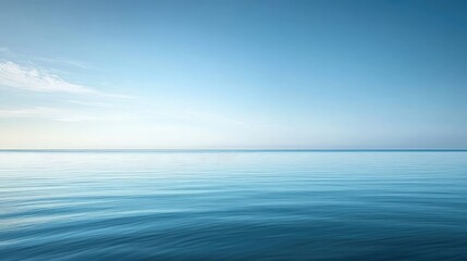 Fototapeta premium Calm blue water under the clear summer sky, with soft reflections creating a soothing, peaceful background.