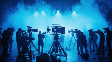 Fototapeta premium Film Crew with Cameras in Blue Smoke Studio
