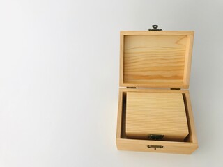 One closed handmade small wooden box is inside another larger wooden box on a white background with copy space on the left side of the frame