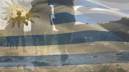 Animation of flag of uruguay over diverse soldiers with guns - Powered by Adobe