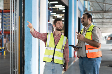 Warehouse concept. Two male warehouse worker working and checking, receive of products in warehouse