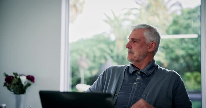 Senior, frustrated man and laptop with headache for financial crisis, loss or debt review at home. Mature, angry male person or stress with computer for finance disaster, mistake or struggle at house