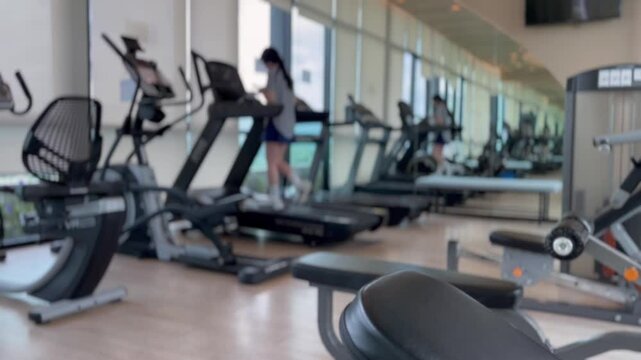 Running on Treadmill, Fitness Gym Exercise, walking on gym machine. Cardio walk. Athletic and muscular man training in modern gym. Runner training for marathon indoors, Defocus blur background
